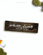 Dark brown wooden sign with 'welcome friends, old and new' text written on it, lying on a white background